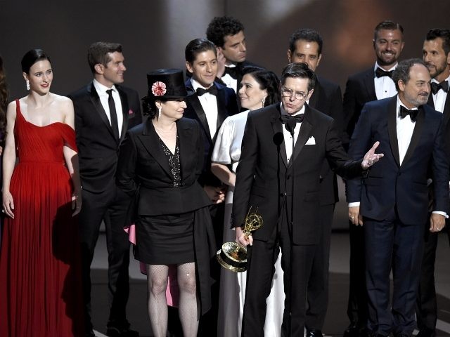 Amy Sherman-Palladino, front and center left, Daniel Palladino and the cast and crew of "The Marvelous Mrs. Maisel" accept the award for outstanding comedy series at the 70th Primetime Emmy Awards on Monday, Sept. 17, 2018, at the Microsoft Theater in Los Angeles. (Photo by Chris Pizzello/Invision/AP)