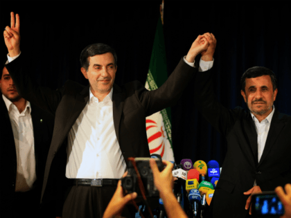Iranian President Mahmoud Ahmadinejad (R) and Esfandyar Rahim Mashaie (L) wave during their press conference after Mashaie registered his candidacy for the upcoming presidential election at the interior ministry in Tehran on May 11, 2013. Iran is expected to wrap up the five-day registration of candidates on May 13, leaving …