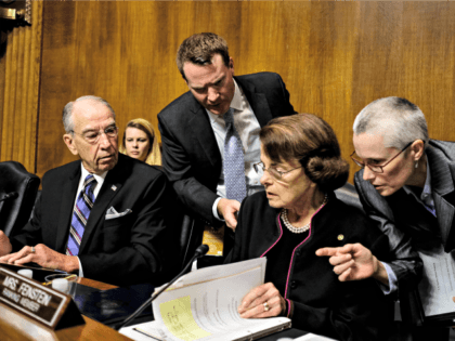 Chairman of the Senate Judiciary Committee Charles Grassley, R-Iowa., , left, and ranking member Sen. Dianne Feinstein, D-Calif., huddle with aides during the Senate Judiciary Committee hearing with Christine Blasey Ford, Thursday, Sept. 27, 2018 on Capitol Hill in Washington.
