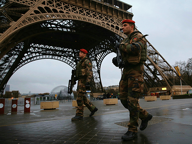 PARIS, FRANCE - JANUARY 09: Armed security patrols around the Eiffel Tower on January 9, 2015 in Paris, France. A huge manhunt for the two suspected gunmen in Wednesday's deadly attack on Charlie Hebdo magazine has entered its third day. (Photo by Dan Kitwood/Getty Images)