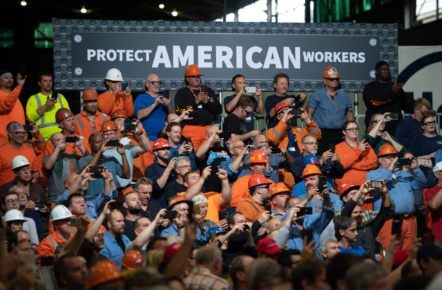 Workers listen as US President Donald Trump speaks about trade at US Steel's Granite