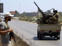 Libyan security forces patrol on August 23, 2018 near the site of an attack on a checkpoint in the city of Zliten, 170 km east of the capital Tripoli. - An attack on a checkpoint between the Libyan capital and the town of Zliten killed six soldiers of the UN-backed …