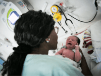 GettyImages-1024818918 A nursing auxiliary takes care of a newborn baby on July 7, 2018 at the hospital in Nantes, western France. (Photo by LOIC VENANCE / AFP) (Photo credit should read LOIC VENANCE/AFP/Getty Images)