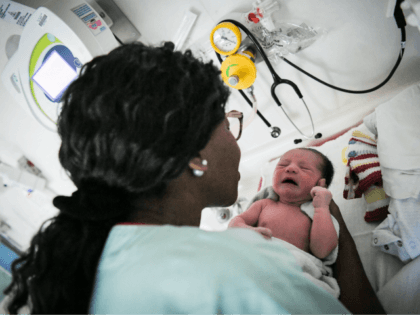 A nursing auxiliary takes care of a newborn baby on July 7, 2018 at the hospital in Nantes, western France. (Photo by LOIC VENANCE / AFP) (Photo credit should read LOIC VENANCE/AFP/Getty Images)
