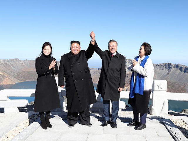 MOUNT PAEKTU, NORTH KOREA - SEPTEMBER 20: (EDITORIAL USE ONLY, NO COMMERCIAL USE) North Korean leader Kim Jong Un (2nd L) and his wife Ri Sol Ju (L) pose with South Korean President Moon Jae-in (2nd R) and his wife Kim Jung-sook (R) on the top of Mount Paektu on September 20, 2018 in Mount Paektu, North Korea. Kim and Moon meet for the Inter-Korean summit talks after the 1945 division of the peninsula, where they will discuss ways to denuclearize the Korean Peninsula. (Photo by Pyeongyang Press Corps/Pool/Getty Images)