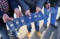 GERMANY-SWEDEN-EUROPE-MIGRANTS Migrants show passports from Iraqi and Syrian fellow travellers they have to present to buy ferry tickets for their passage to Sweden on November 12, 2015 at the port of Rostock, northeastern Germany, where refugees in transit wait to continue their trip through Europe. Sweden reinstated border controls in a …