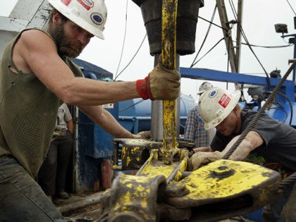 OKAWVILLE, IL - OCTOBER 9: Jerry McKinney (L) and Jeremy Beck work a drilling rig as they