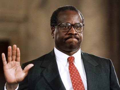 WASHINGTON, DC - SEPTEMBER 10: US Supreme Court nominee Clarence Thomas raises his right h