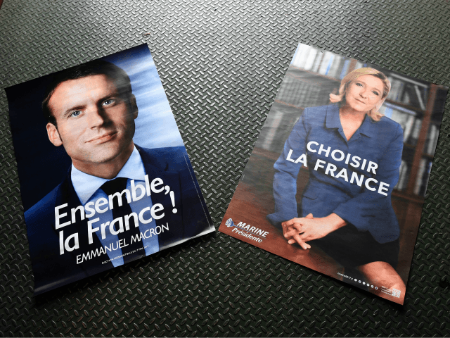 Electoral posters of French presidential election candidate for the En Marche ! movement Emmanuel Macron (L) and French presidential election candidate for the far-right Front National (FN) party Marine Le Pen (R) are displayed in a warehouse in Gonesse, north of Paris on April 26, 2017, ahead of the second …