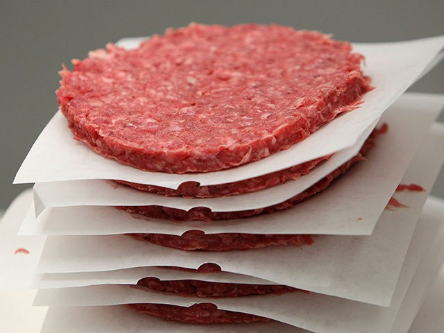 SAN FRANCISCO - JUNE 24: A stack of ground beef patties moves on a conveyor belt at a meat