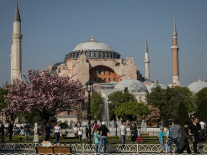 People Walk in front of the Hagia Sofia in Sultanahmet on April 24, 2018 in Istanbul, Turkey. As peak tourism season approaches early booking figures and foreign demand suggest Turkey will reach a record of 40 million visitors in 2018. The tourism sector suffered big losses in 2016 due to …