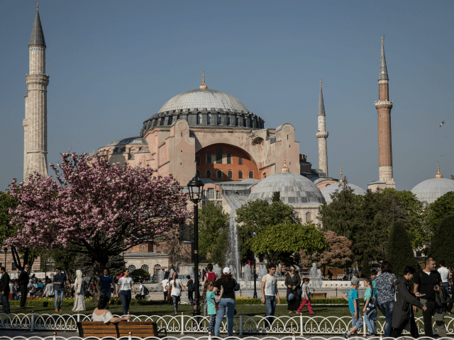 People Walk in front of the Hagia Sofia in Sultanahmet on April 24, 2018 in Istanbul, Turk