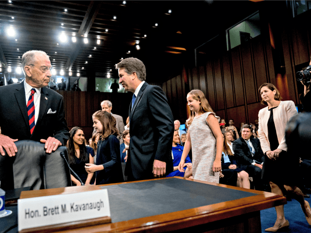 President Donald Trumps Supreme Court nominee, Brett Kavanaugh, center, a federal appeals court judge, accompanied by Senate Judiciary Chairman Chuck Grassley, R-Iowa, left, arrives with his family for a Senate Judiciary Committee hearing on Capitol Hill in Washington, Tuesday, Sept. 4, 2018, to begin his confirmation to replace retired Justice â¦