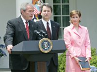 President Bush, speaks in the Rose Garden of the White House before the swearing-in of Brett Kavanaugh, center, as Judge for the U.S. Court of Appeals for the District of Columbia Thursday, June 1, 2006 in Washington. Holding the Bible is Kavanaugh's wife Ashely Kavanaugh.