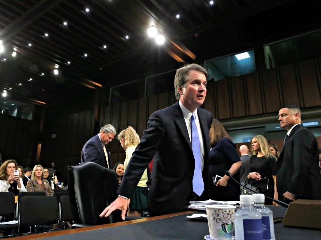 President Donald Trump's Supreme Court nominee, Brett Kavanaugh, takes his seat after a br