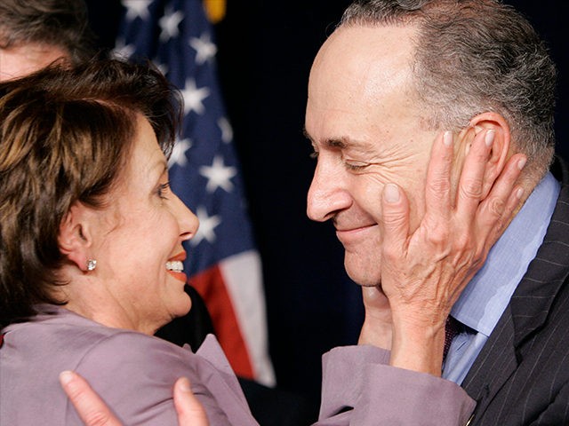 House Minority Leader Nancy Pelosi, D-Calif., hugs Sen. Chuck Schumer, D-N.Y., at the Demo