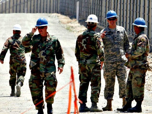 In this June 21, 2006, file photo, members of the California National Guard work next to t