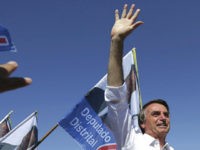 National-Social-Liberal-Party-presidential-candidate-Jair-Bolsonaro-Brazil-AP National Social Liberal Party presidential candidate Jair Bolsonaro greets supporters during a campaign rally in Brasilia's Ceilandia neighborhood, Brazil, Wednesday, Sept. 5, 2018. Brazilians go to the polls on October 7 to cast their vote for a new president. (AP Photo/Eraldo Peres)