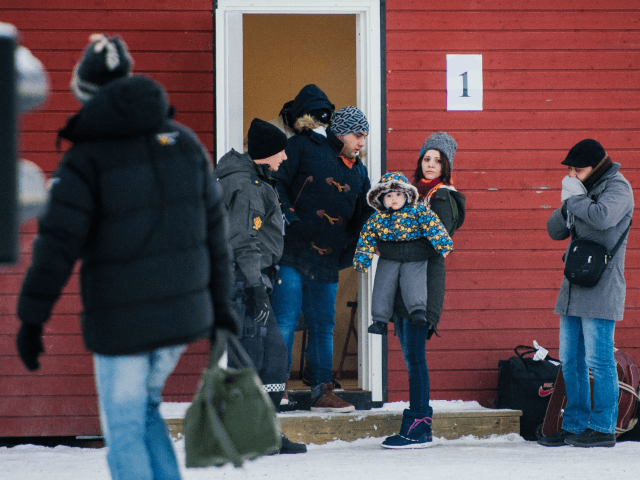 Refugees are welcomed upon arrival at the Norwegian border crossing station at Storskog af