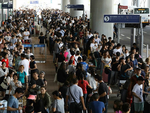 Passengers stranded overnight at the Kansai International Airport due to typhoon Jebi queu