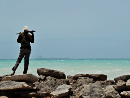 TO GO WITH AFP STORY BY JEAN-MARC MOJON A pirate stands on a rocky outcrop on the coast in