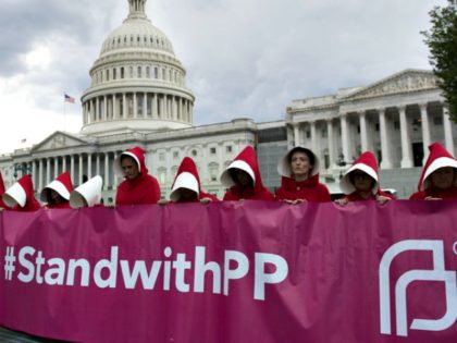 Supporters of Planned Parenthood dressed as characters from The Handmaid's Tale protest la