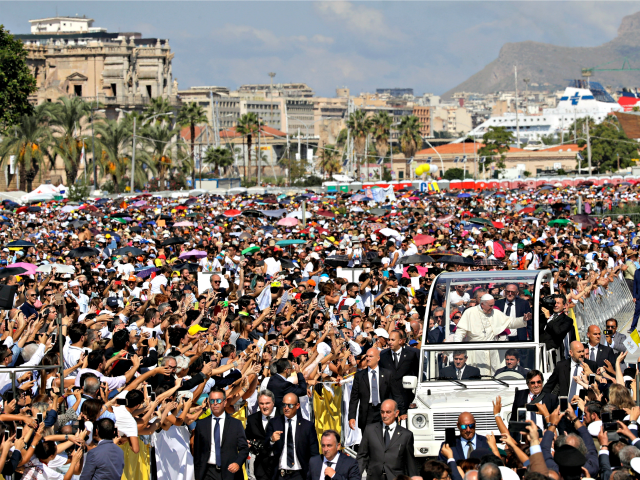 Pope Francis is driven through the crowd in Palermo, Italy, Saturday, Sept. 15, 2018. Pope