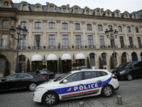 A police car drives past the Ritz hotel in Paris, Thursday, Jan. 11, 2018. Paris police have recovered some jewels stolen from the Ritz Hotel in a multimillion-euro robbery attempt, but are still searching Thursday for two thieves and the rest of the missing luxury merchandise. (AP Photo/Michel Euler)