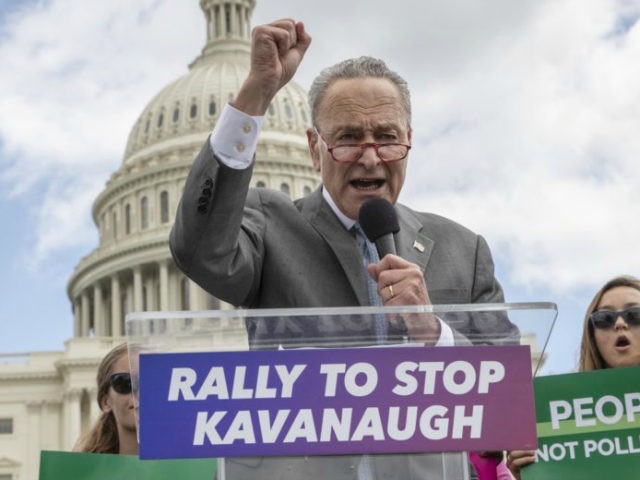 In this Aug. 1, 2018 file photo, Senate Minority Leader Chuck Schumer, D-N.Y., joins protesters objecting to President Donald Trump's Supreme Court nominee Brett Kavanaugh at a rally Capitol in Washington. Schumer, who plans to meet Kavanaugh privately early this week, is methodically building arguments that would help vulnerable Democratic â€¦