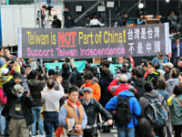 Pro-independence supporters carry a banner shouting that Taiwan is not part of China outside of the Democratic Progressive Party, or DPP, presidential campaign headquarters Saturday, Jan. 16, 2016, in Taipei, Taiwan. Taiwanese turned out to vote for a new president Saturday, with the China-friendly Nationalist Party likely to lose power …