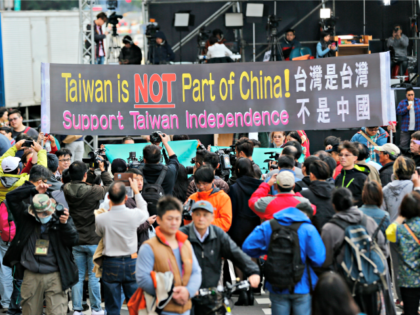 Pro-independence supporters carry a banner shouting that Taiwan is not part of China outsi