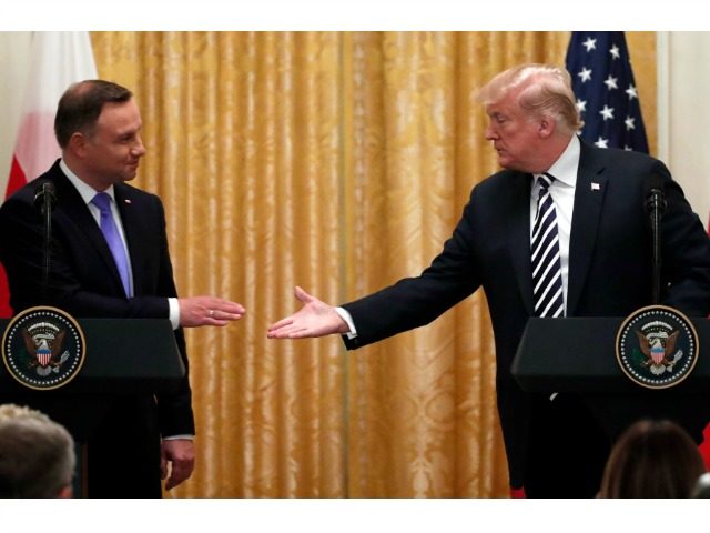 President Donald Trump shakes hands with Polish President Andrzej Duda, left, during a news conference in the East Room of the White House, Tuesday, Sept. 18, 2018, in Washington.