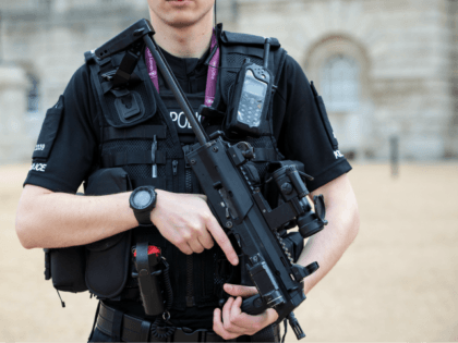 LONDON, ENGLAND - SEPTEMBER 16: An armed police officer patrols in Horse Guards Parade on