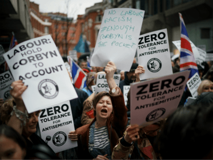 Campaigners from the Campaign Against Antisemitism demonstrate and listen to speakers outs