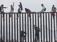 border-fence-crossing-mexico-getty Migrant caravan demonstrators climb the US-Mexico border fence during a rally, on April 29, 2018, in San Ysidro, California. - The US has threatened to arrest around 100 Central American migrants if they try to sneak in from the US-Mexico border where they have gathered, prompting US President Donald Trump …