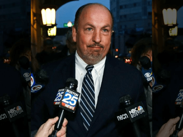 Former Massachusetts State Sen. Brian Joyce is surrounded by reporters as he leaves the U.