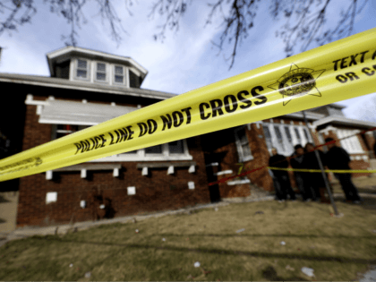 Crime scene tape surrounds a home on Sunday, Feb. 7, 2016, in Chicago. Police said they be