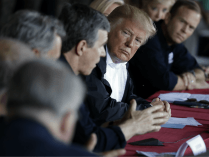 President Donald Trump listens as North Carolina Gov. Roy Cooper speaks while attending a briefing, after arriving at Marine Corps Air Station Cherry Point to visit areas impacted by Hurricane Florence, Wednesday, Sept. 19, 2018, in Havelock, N.C. FEMA Administrator Brock Long is leaning in a right. (AP Photo/Evan Vucci)