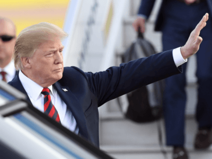 US President Donald Trump waves upon arrival at Helsinki-Vantaa Airport in Helsinki, on Ju