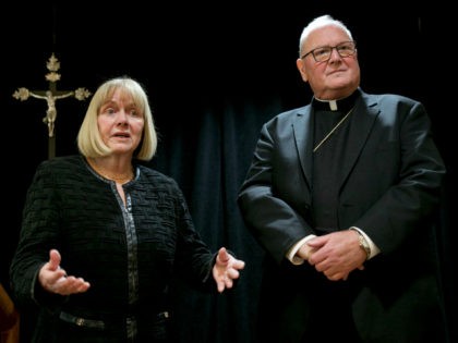 Former federal judge Barbara Jones and Cardinal Timothy Dolan address a news conference at