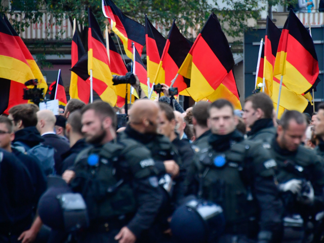 Supporters of the far-right Alternative for Germany (AfD) party wave German flags as they