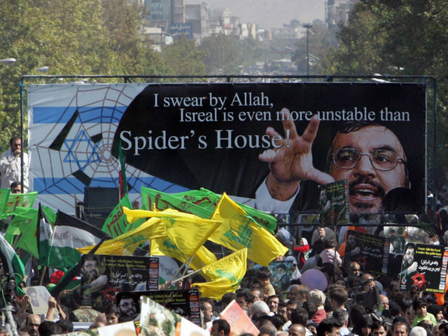 Iranian protestors, holding up a huge banner with the picture of Lebanon's Hezbollah leader Hassan Nasrallah and waving yellow flags of the Shiite Muslim guerrilla group, take part in a demonstration held in Tehran to mark Jerusalem (Al-Quds) Day, 20 October 2006. Iranian President Mahmoud Ahmadinejad said in a speech …