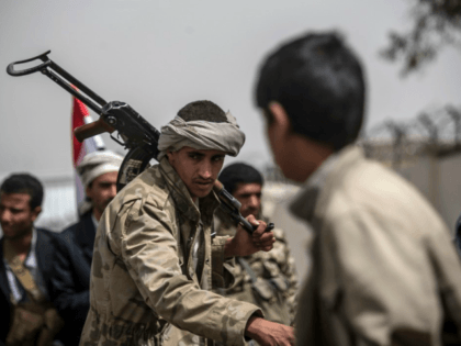 Shiite Houthi tribesmen perform a traditional dance during a tribal gathering showing supp