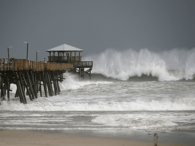 Waves crash around the Oceana Pier as the outer edges of Hurricane Florence being to affec