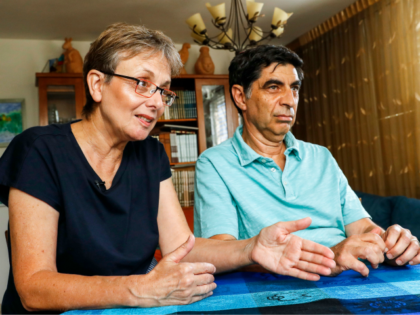Leah (L) and Simha (R) Goldin, the parents of Israeli soldier Lieutenant Hadar Goldin, speak during an interview with AFP at their family home in the central Israeli city of Kfar Saba on August 29, 2018. - From the living room of their home in central Israel, surrounded by books …