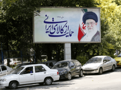 Cars drive by a poster depicting Iran's Supreme Leader Ayatollah Ali Khamenei in the capital Tehran on July 31, 2018. (Photo by ATTA KENARE / AFP) (Photo credit should read ATTA KENARE/AFP/Getty Images)