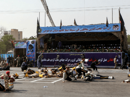 This picture taken on September 22, 2018 in the southwestern Iranian city of Ahvaz shows injured soldiers lying on the ground at the scene of an attack on a military parade that was marking the anniversary of the outbreak of its devastating 1980-1988 war with Saddam Hussein's Iraq. - Dozens …