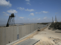 In this Wednesday, Sept. 5, 2018, photo, a bulldozer works near a wall at the Israel Lebanon border near Rosh Haniqra, northern Israel, Israel is building a massive wall along its northern border, saying the barrier is needed to protect civilians from Hezbollah attacks, but the project has raised tensions …