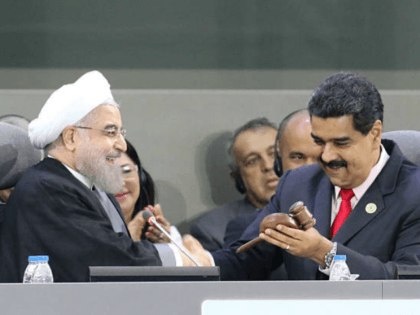 Handout picture released by the Venezuelan presidency showing Iranian President Hassan Rouhani (L) and Venezuelan President Nicolas Maduro talk during the opening ceremony of the Non-Aligned Movement summit in Porlamar, Margarita Island, Venezuela, on September 17, 2016 With the left increasingly isolated by a crushing political and economic crisis, Venezuela …