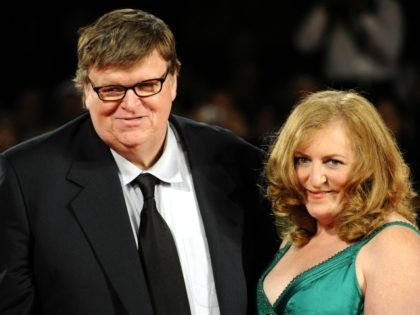 US director Michael Mooreand his wife Kathleen Glynn arrive for the screening of 'Cap